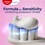 A close-up of Colgate Sensitive Complete Protection Toothpaste on a toothbrush head. In text: Formula for sensitivity containing potassium nitrate.