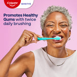 A woman brushing her teeth with Colgate Sensitive Complete Protection Toothpaste. In text: Promotes healthy gums with twice daily brushing.