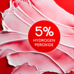 Colgate Optic White Pro Series Stain Prevention Whitening Toothpaste smeared on a red background. In text: 5% hydrogen peroxide.