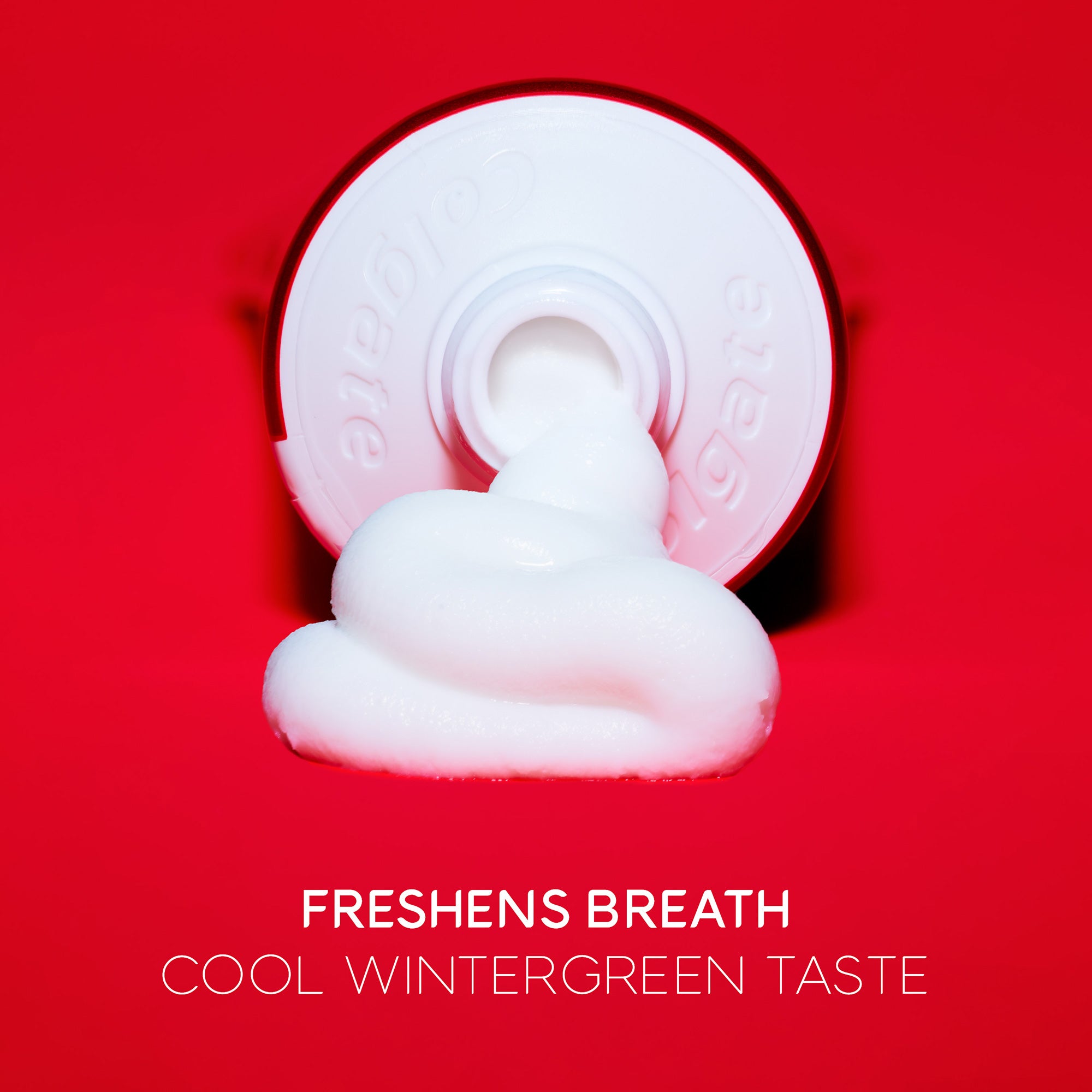 Colgate Optic White Pro Series Stain Prevention Whitening Toothpaste flowing out of a tube. In text: Freshens breath. Cool wintergreen taste.